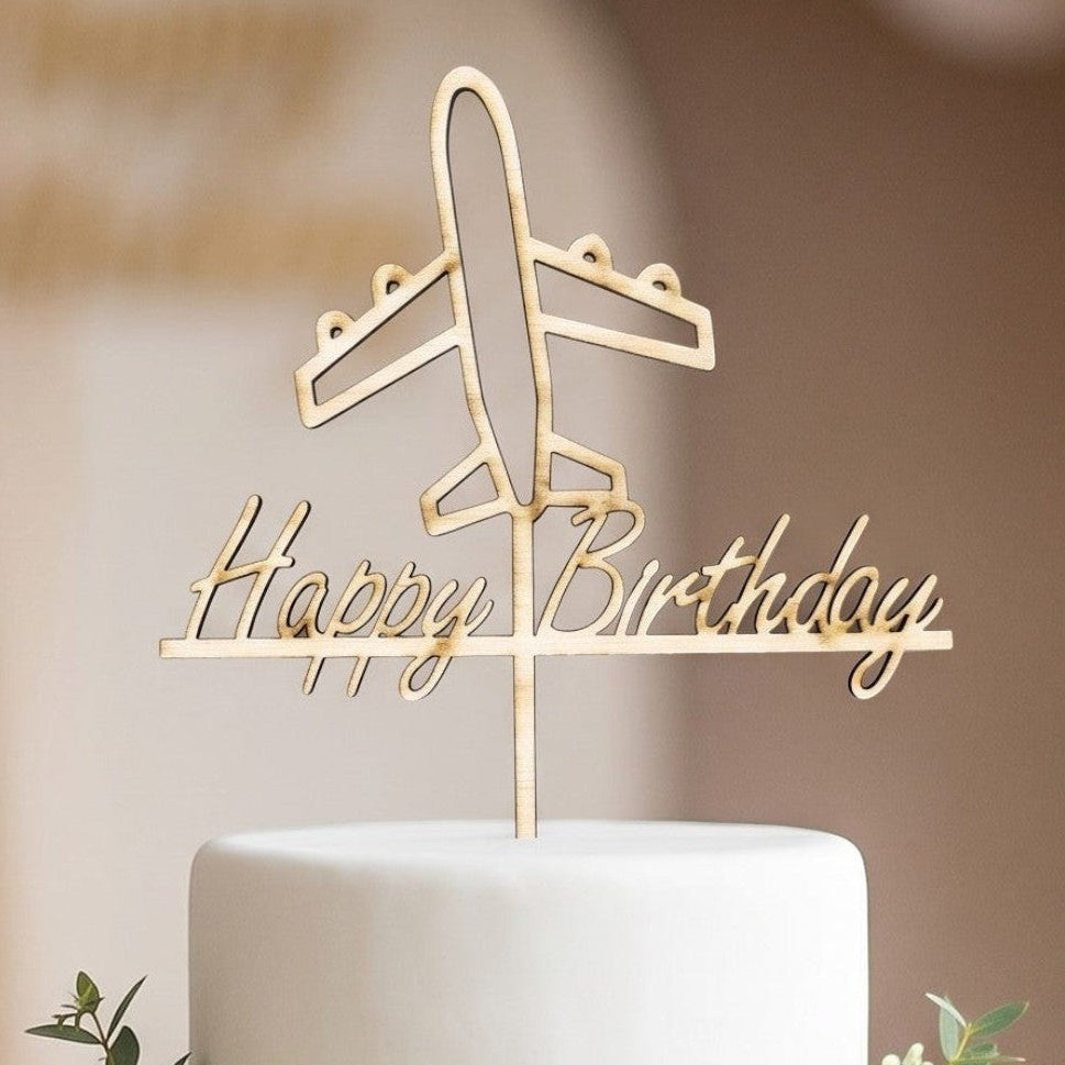 Wooderland wooden Happy Birthday cake topper with an airplane design on a two-tier blue and white birthday cake.