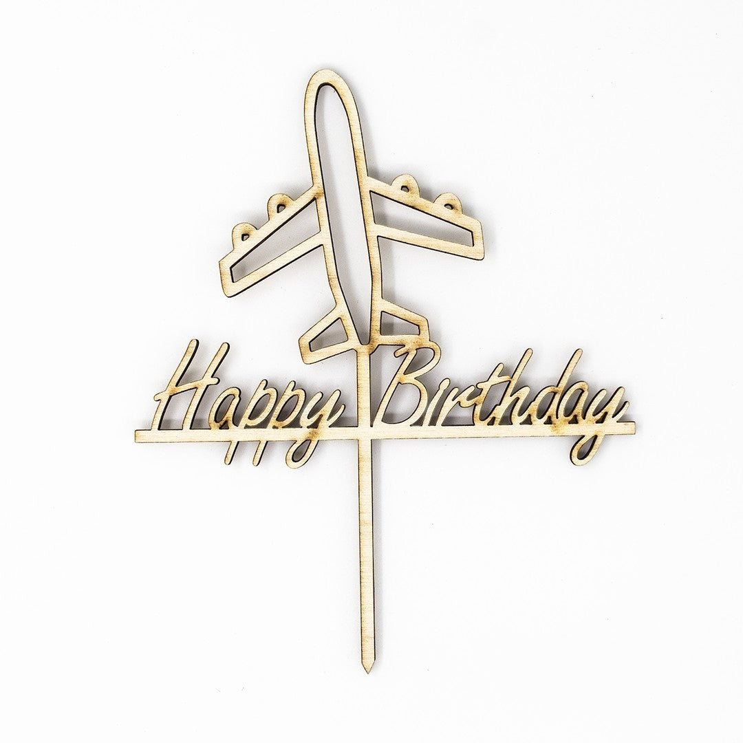 Wooderland laser-cut wooden cake topper featuring an airplane and Happy Birthday text in a playful script font.