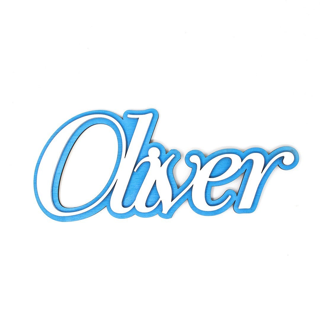 Wooderland custom layered wooden name sign with white script letters on a blue background for nursery wall decor