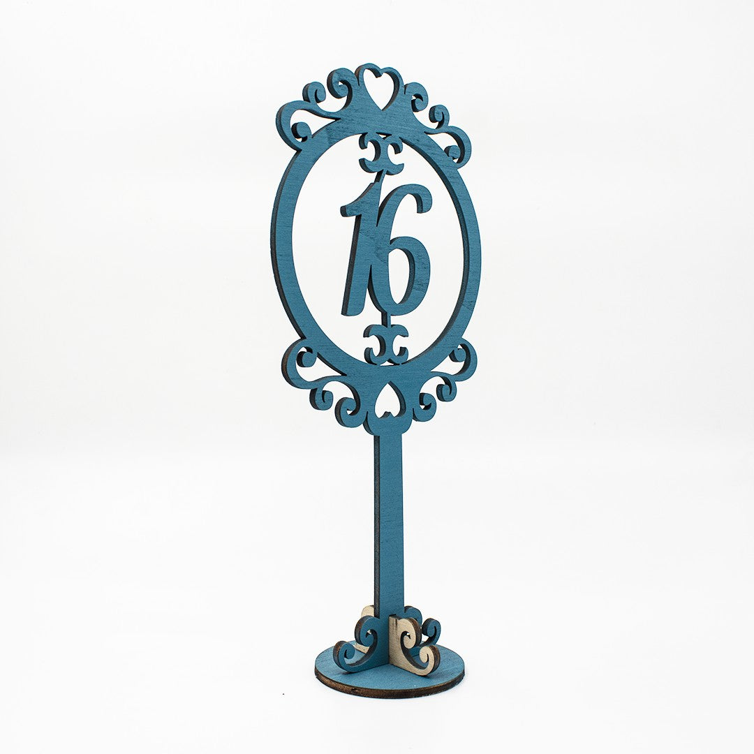 Wooderland blue wooden table number 16 with ornate scrollwork frame for wedding or event decor.