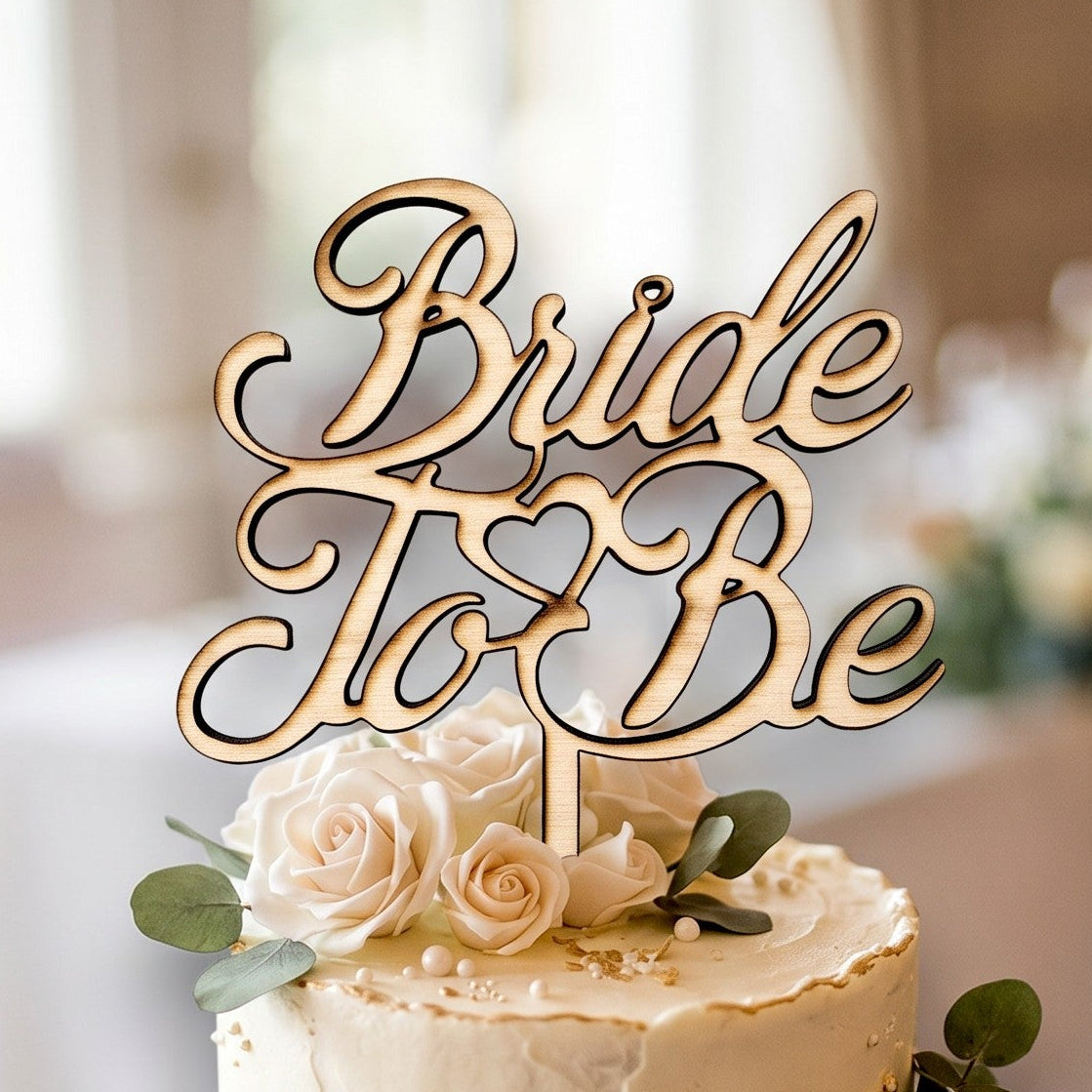 Wooderland Bride to Be wooden cake topper in natural plywood with elegant laser-cut script on a tiered wedding cake.