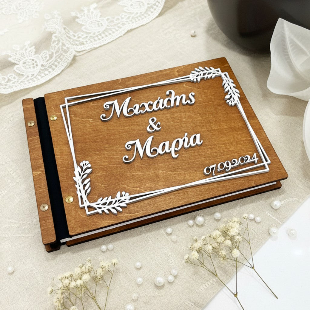 Wooderland custom engraved wooden wedding guest book with white 3D text and floral frame on a lace background.