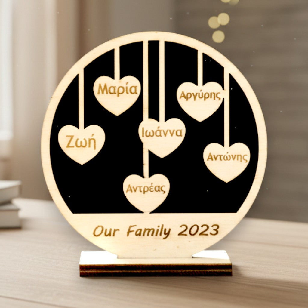 Wooderland custom wooden family circle sign with hanging heart name tags on a desk in a cozy home setting.