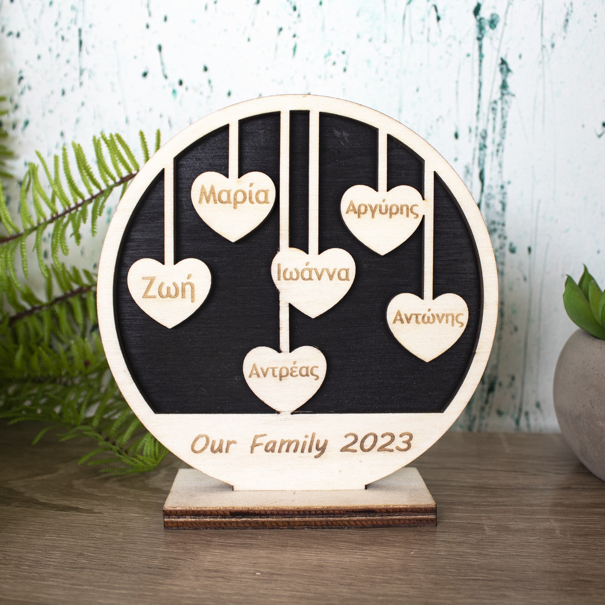 Wooderland custom wooden family circle sign with hanging heart name tags on a black background