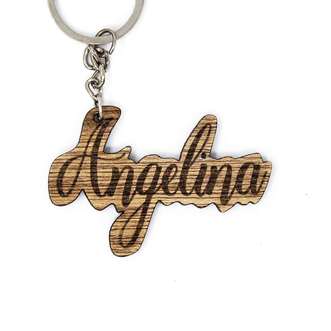 Wooderland custom wooden keyring with the name Angelina engraved in elegant cursive script on a metal ring.