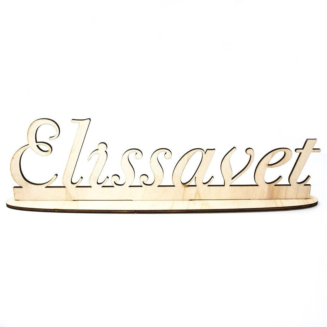 Wooderland custom laser-cut wooden name sign with a sturdy freestanding base in a natural light wood finish.