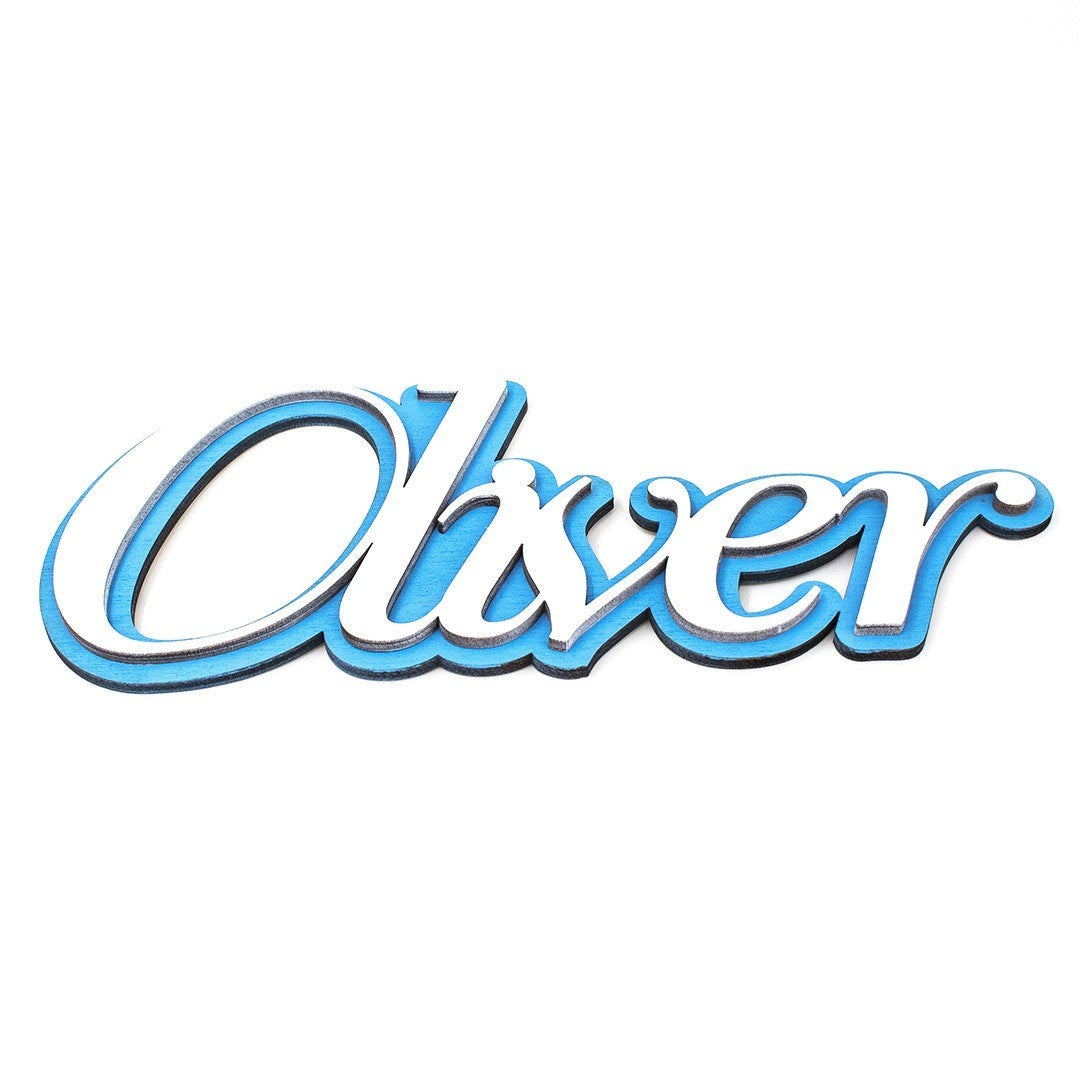 Wooderland custom layered wooden name sign for nursery featuring the name Oliver in white letters on a blue background