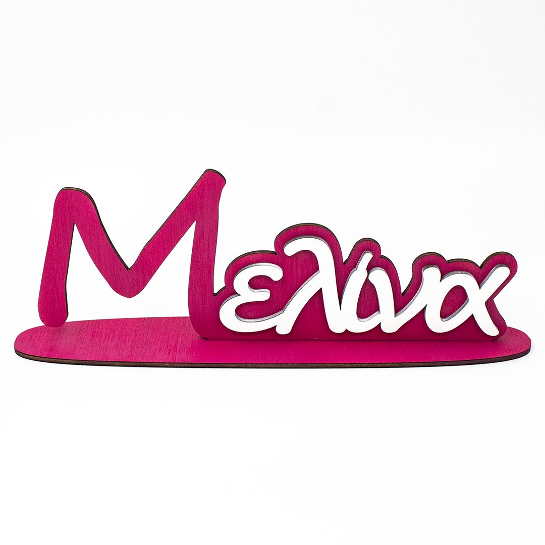 Wooderland custom two-tone wooden name stand in fuchsia and white for a child's room or christening decor.