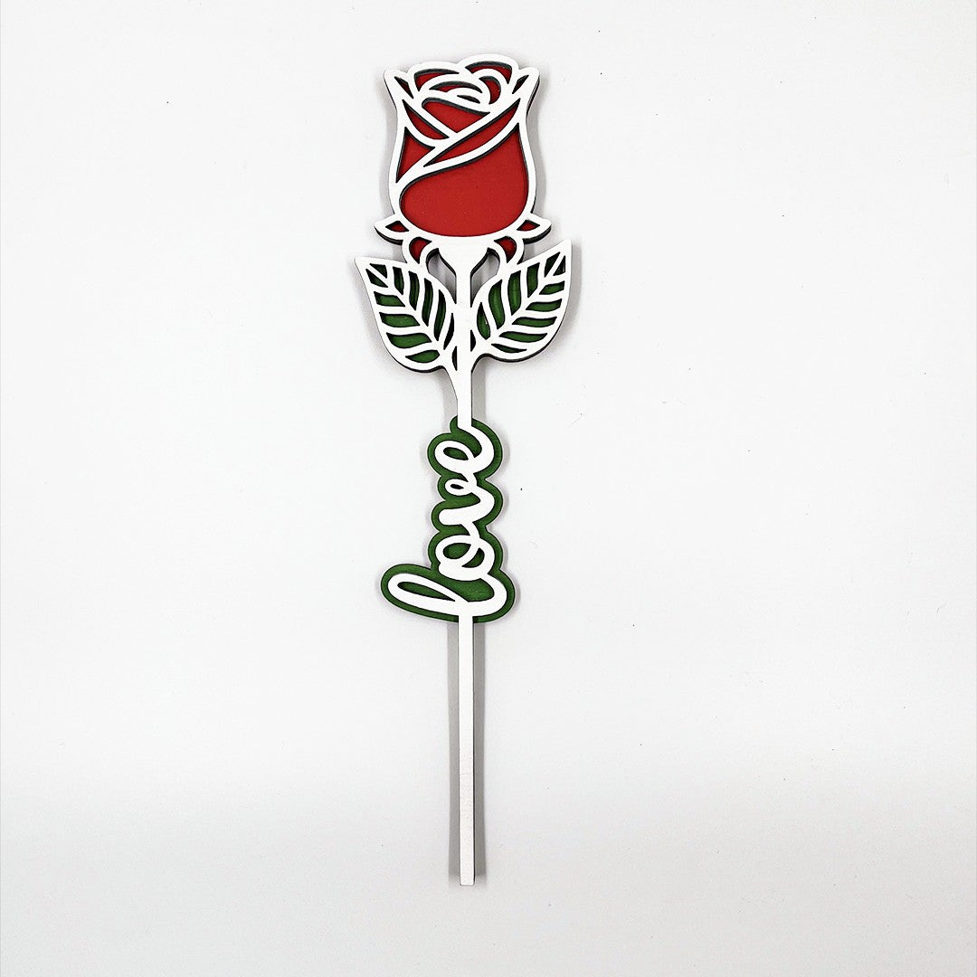 Wooderland engraved wooden rose featuring a red bloom, green leaves, and the word Love in a script font.