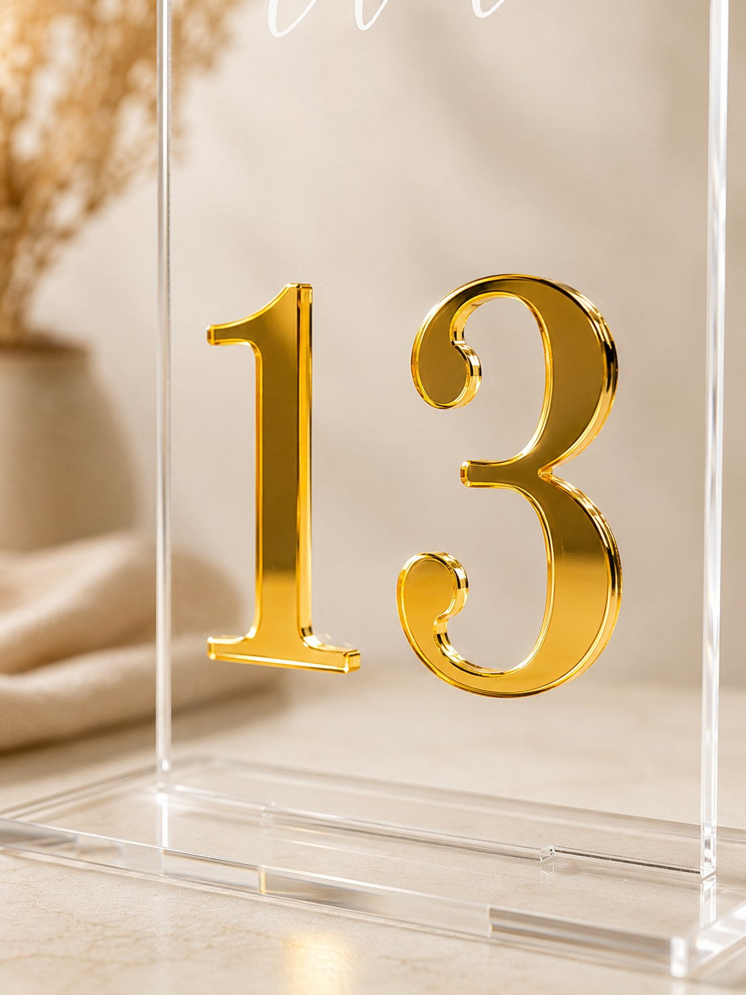 Wooderland clear acrylic wedding table number sign with a gold mirror number 13 and a matching freestanding base.