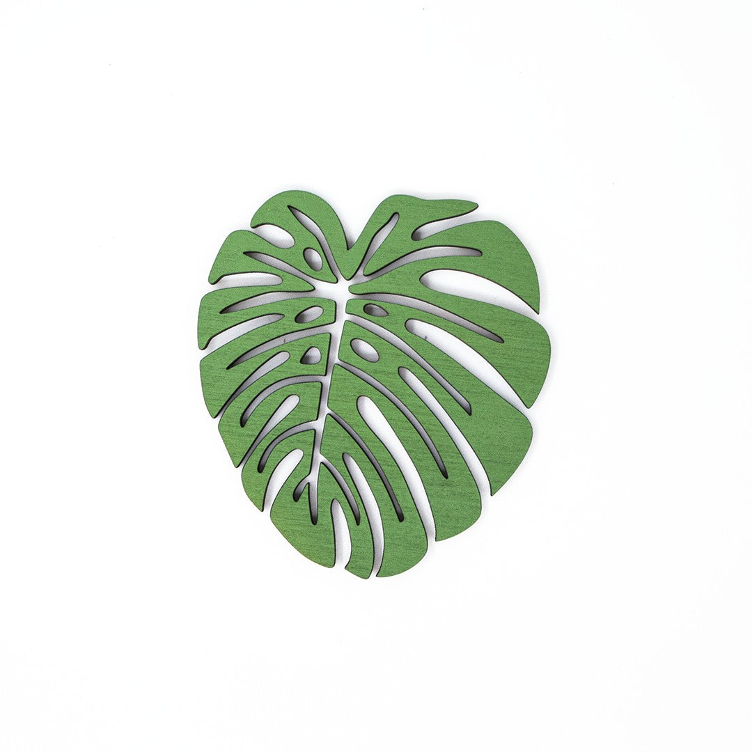 Wooderland green monstera leaf shaped plywood drink coaster on a white background