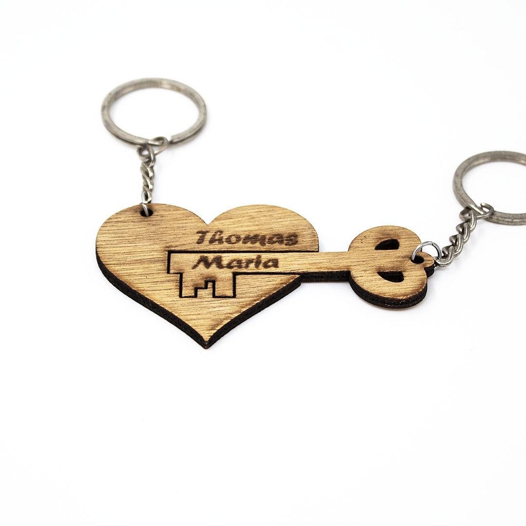 Wooderland heart and key wooden keyring set for couples with engraved names on a white background