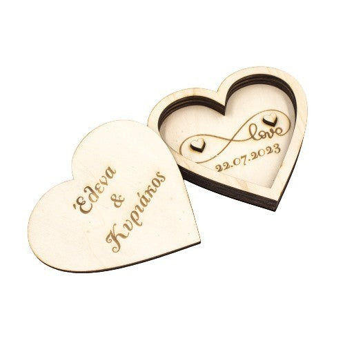 Wooderland heart-shaped wooden wedding ring box with custom engraved names and date on a white background.