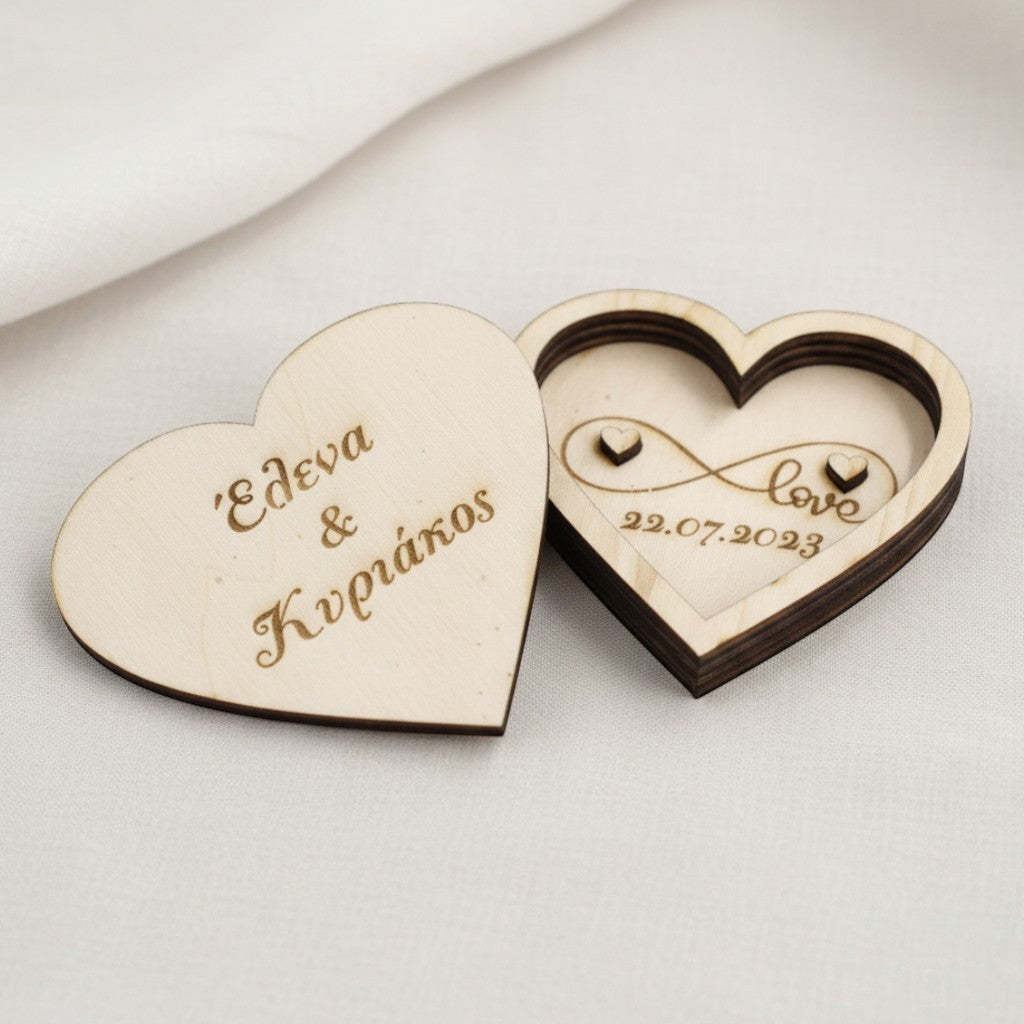 Wooderland heart-shaped wooden wedding ring box with custom engraving and infinity love design on white fabric