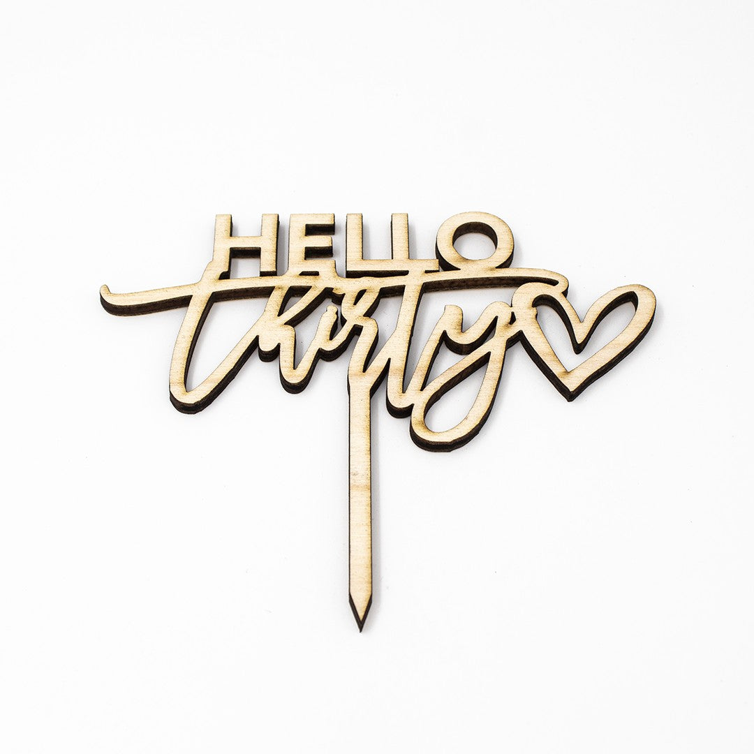 Wooderland Hello Thirty wooden cake topper with laser-cut script and heart detail for a 30th birthday celebration.