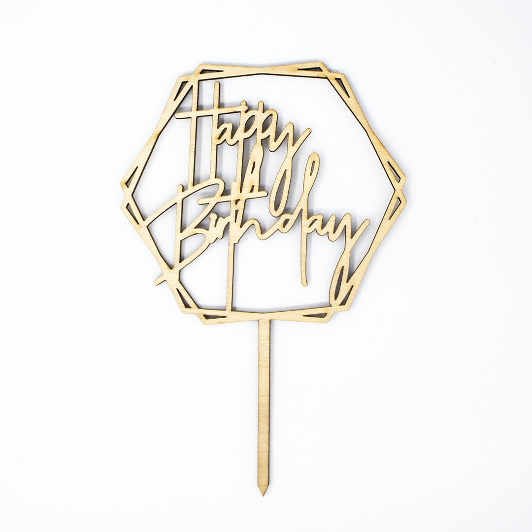 Wooderland laser-cut wooden hexagon cake topper with Happy Birthday script text on a white background.