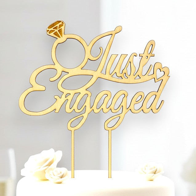Wooderland Just Engaged wooden cake topper with diamond ring detail on a white cake for an engagement party.
