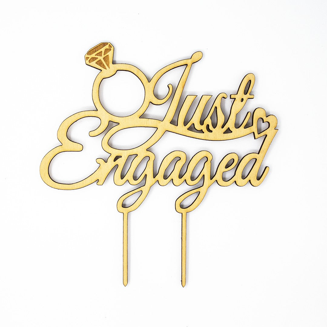 Wooderland Just Engaged wooden cake topper with laser-cut script and diamond ring detail for engagement parties.