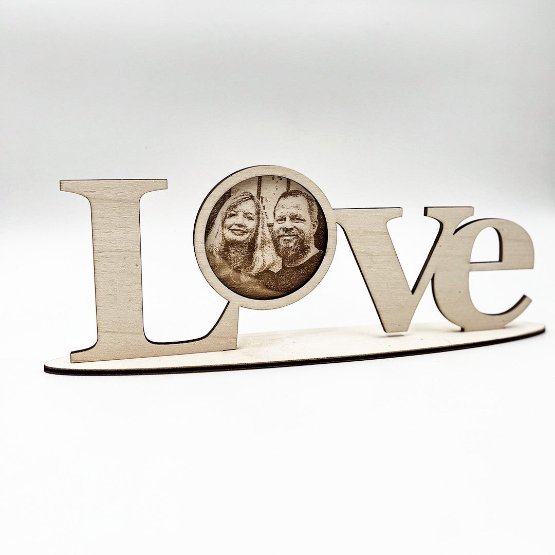 Wooderland laser-cut wooden LOVE standing letters with a personalized circular photo insert on a freestanding base.