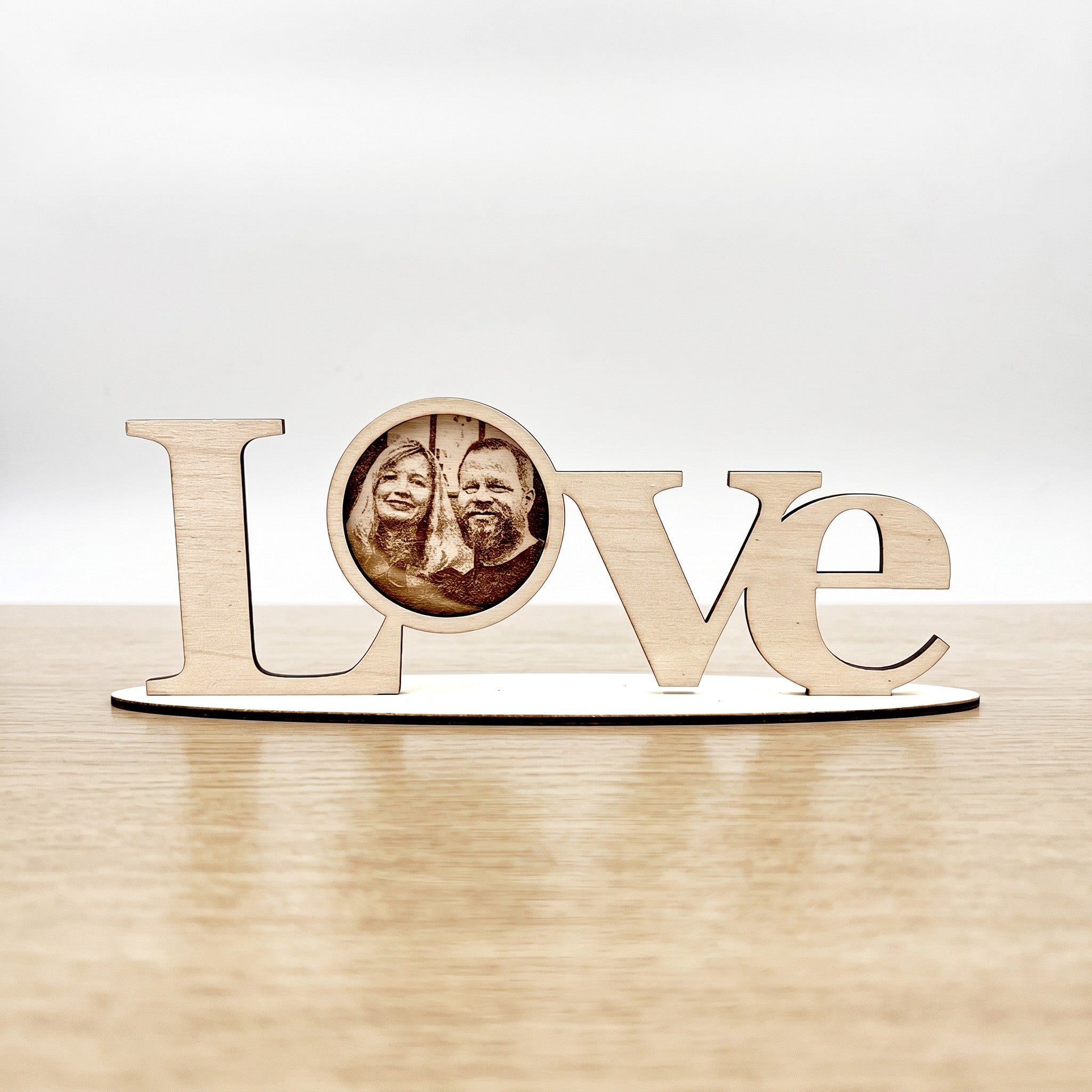 Wooderland laser-cut wooden LOVE standing letters with a personalized circular photo on a freestanding base.