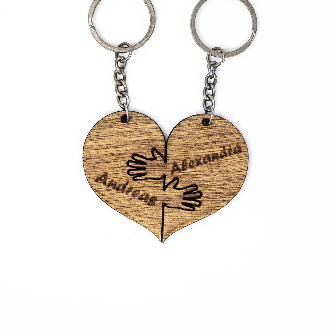 Wooderland matching heart-shaped wooden keyrings with engraved hands and names for couples or friends.