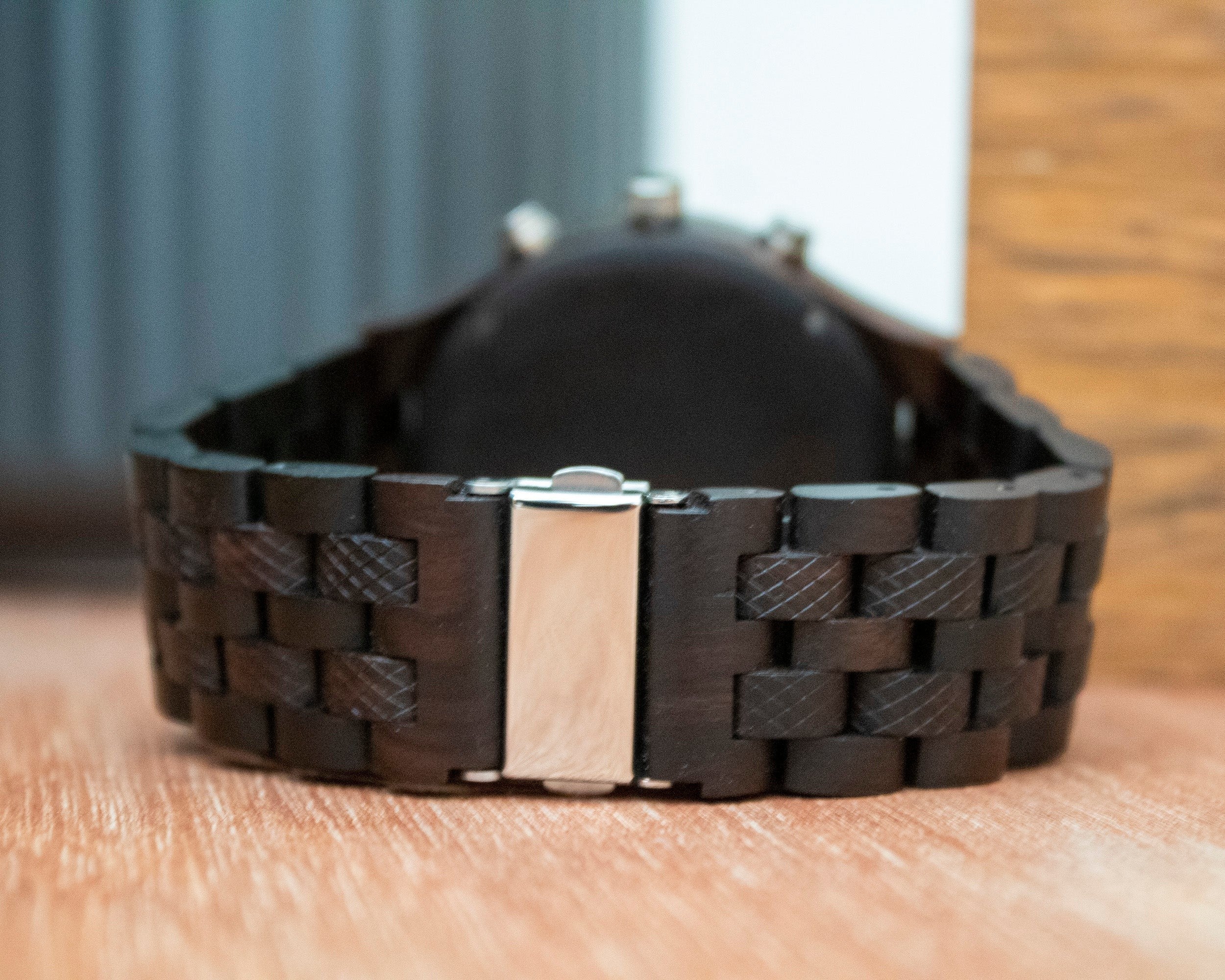 Wooderland Mercury wooden wristwatch featuring a dark textured wood link band with a silver metal clasp closure.