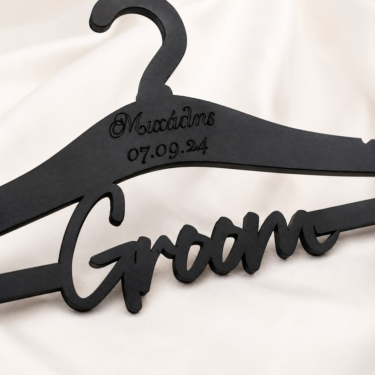 Wooderland matte black wooden wedding hanger with Groom script cut-out, personalized name and date engraving.