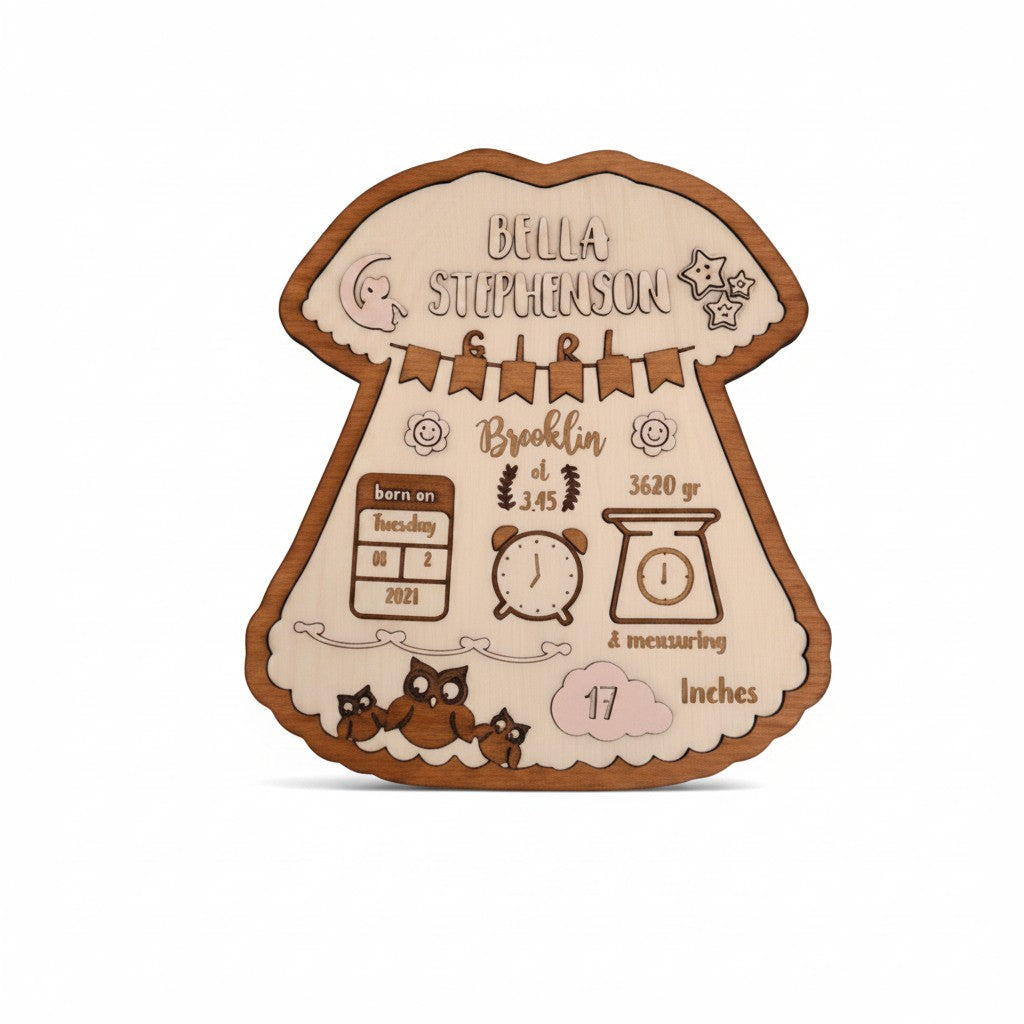 Wooderland personalized wooden baby girl birth announcement sign shaped like a dress with engraved owl illustrations.