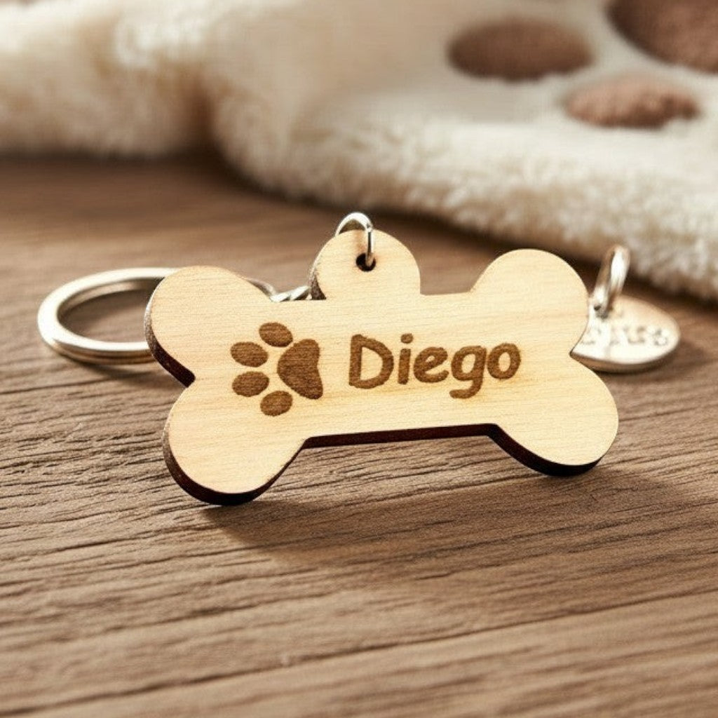 Wooderland personalized wooden dog bone keychain engraved with the name Diego and a paw print on a wooden surface