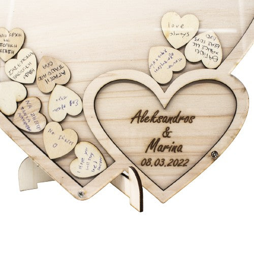 Wooderland custom wooden heart guest book with personalized names and date, featuring small wooden heart inserts.