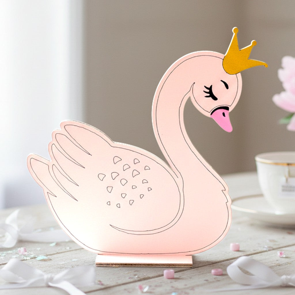 Wooderland freestanding wooden swan figure in soft pink with a gold crown, perfect for nursery or christening decor.