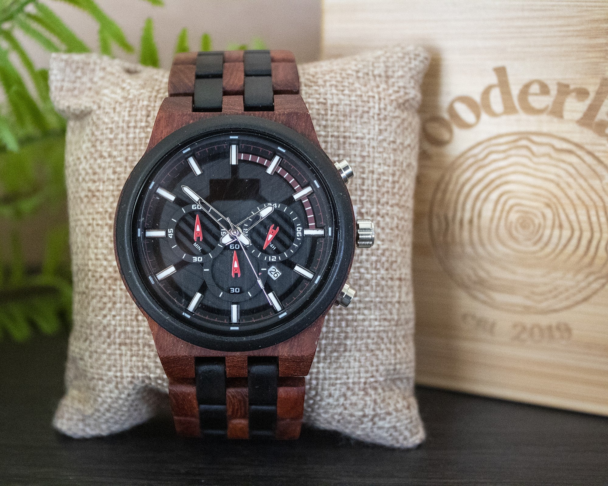 Wooderland Pluto wooden watch with a black dial, multifunctional sub-dials, and a two-tone brown and black wood strap.