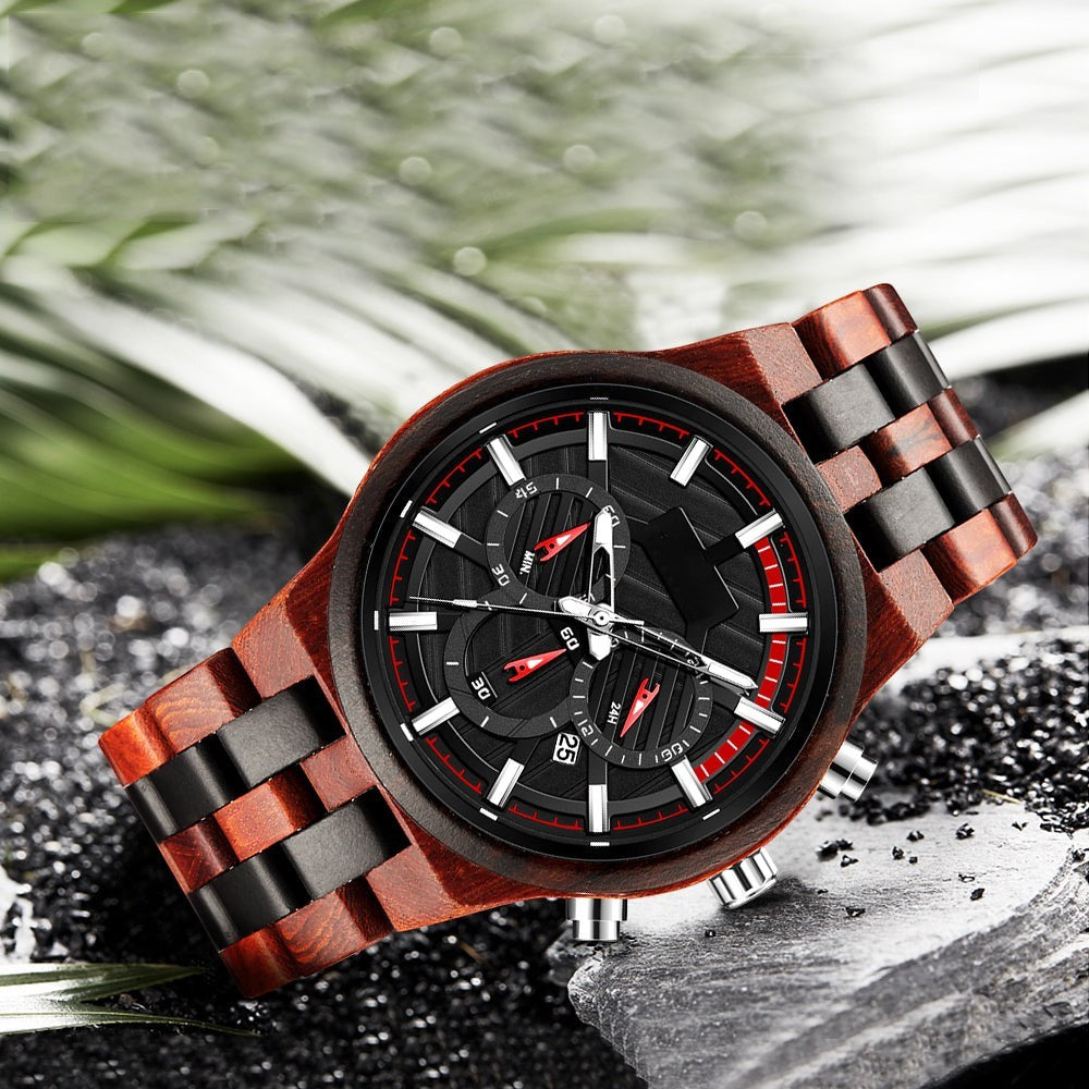 Wooderland Pluto wooden watch with a dark dial, red accents, and a polished wood link strap on a stone surface.