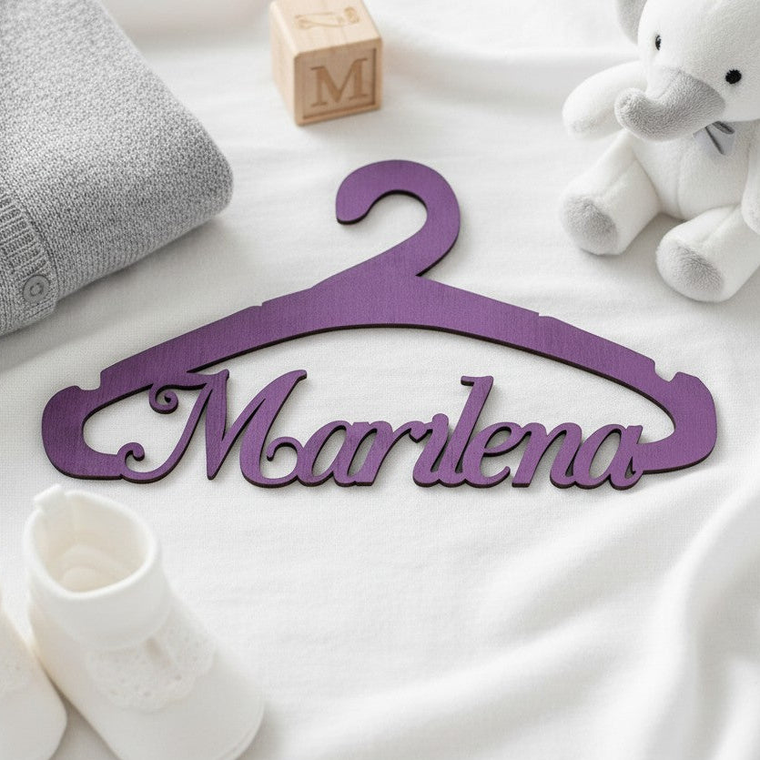 Wooderland personalised purple wooden christening hanger with Marlena name cutout on a white fabric background