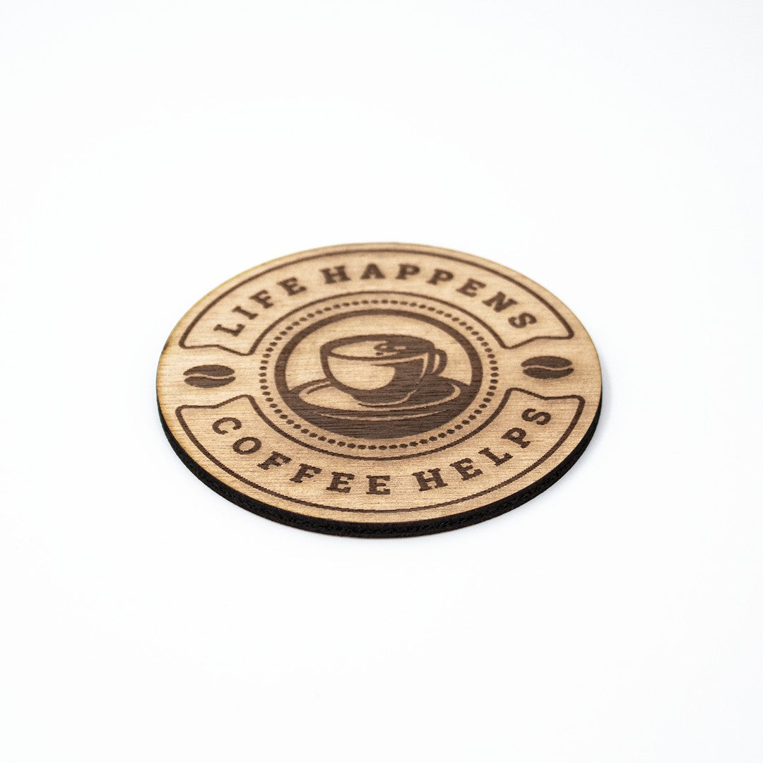 Wooderland round wooden coaster featuring a coffee cup graphic and the text Life Happens Coffee Helps
