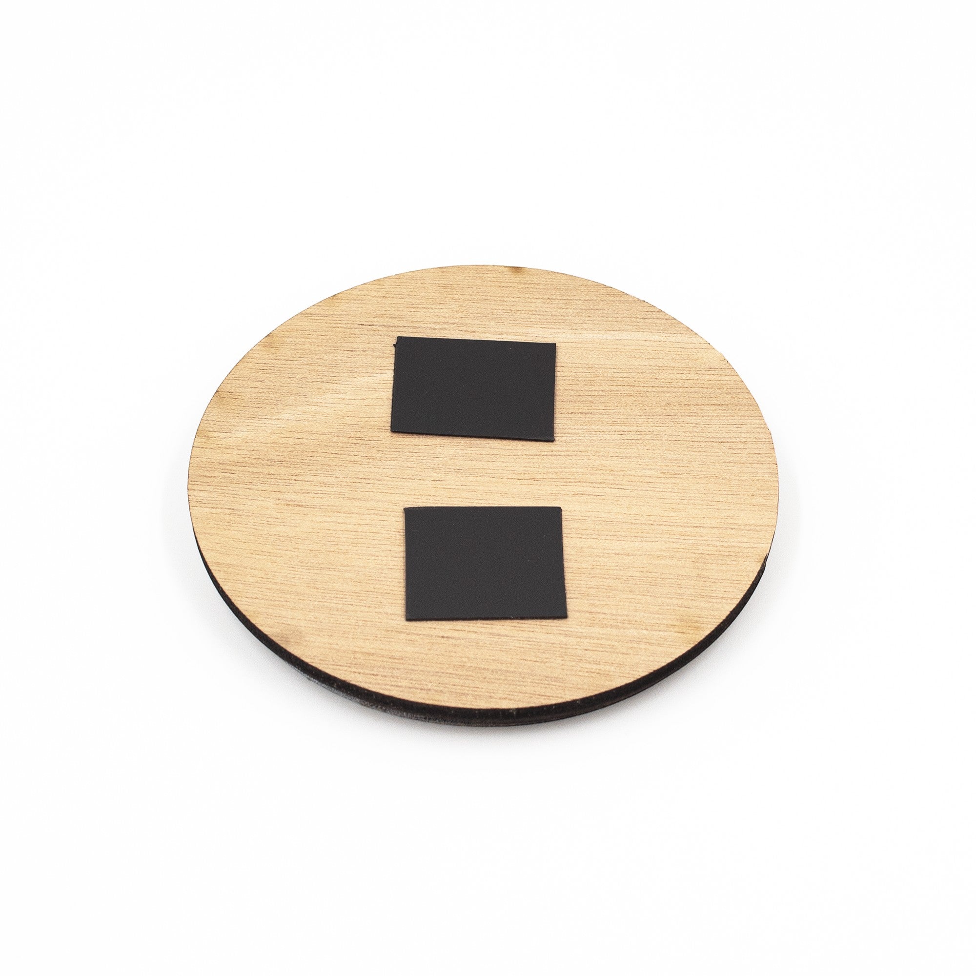 Wooderland round wooden fridge magnet for Mom with two black magnetic squares on the back, isolated on white.