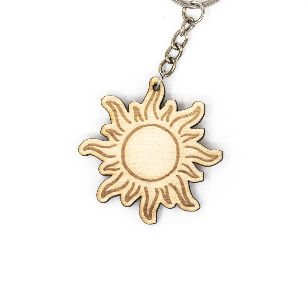 Wooderland sun-shaped wooden keychain with engraved details, perfect as a personalized gift or backpack accessory.