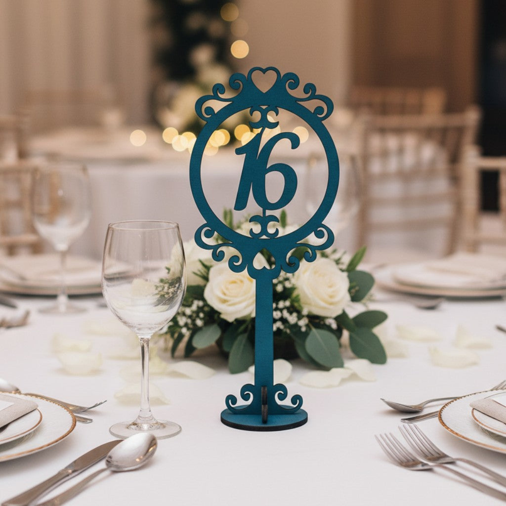 Wooderland freestanding teal wooden table number 16 with ornate circular frame on a decorated wedding table setting