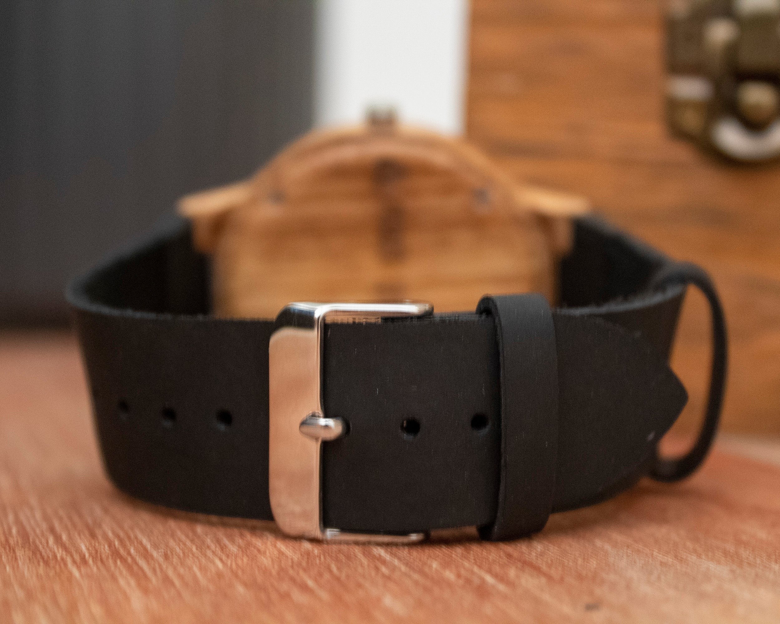 Wooderland Uranus watch featuring a black leather strap with a silver buckle, viewed from the back.