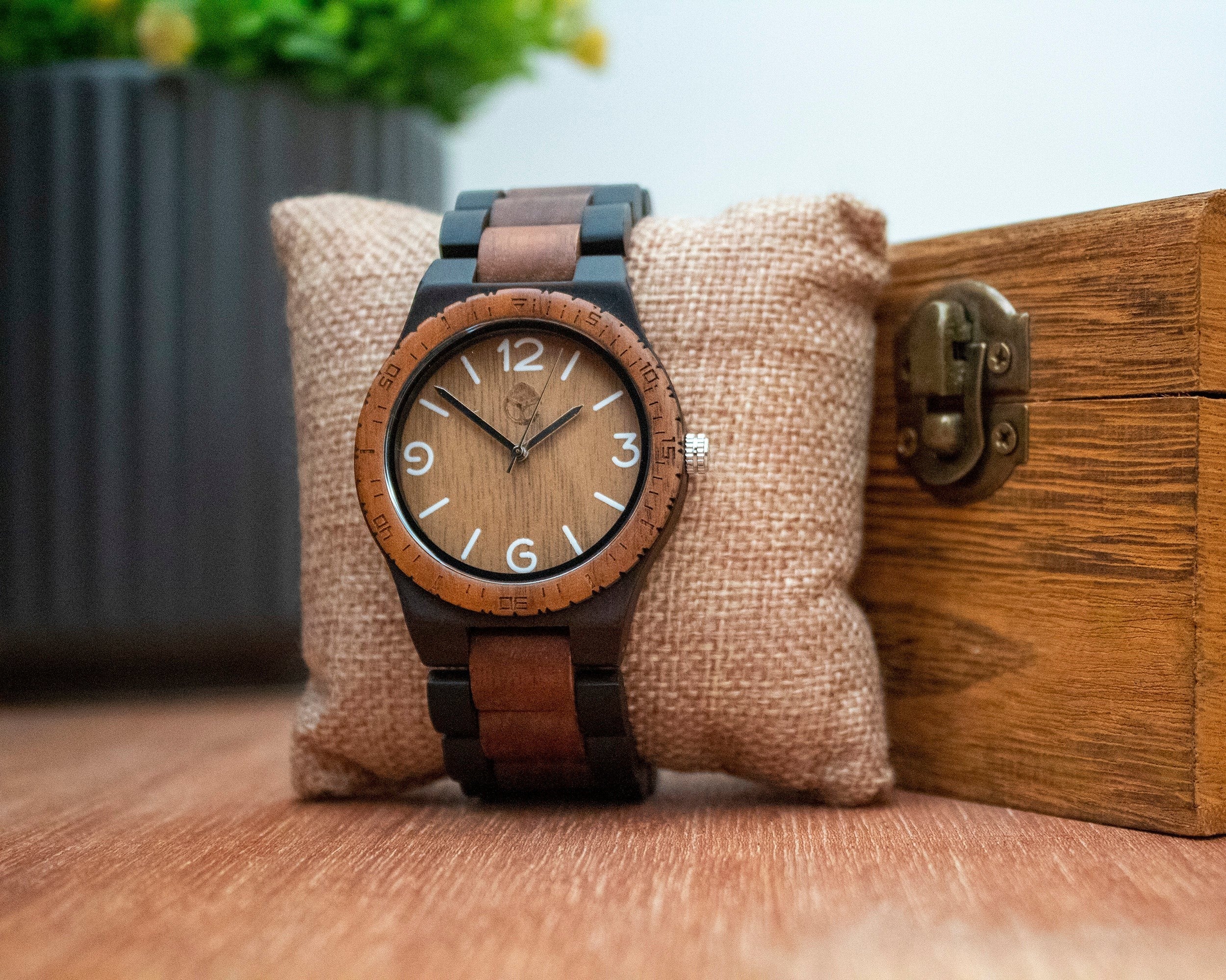 Wooderland Venus wooden watch with bamboo and walnut case and strap, featuring a quartz movement on a burlap pillow.