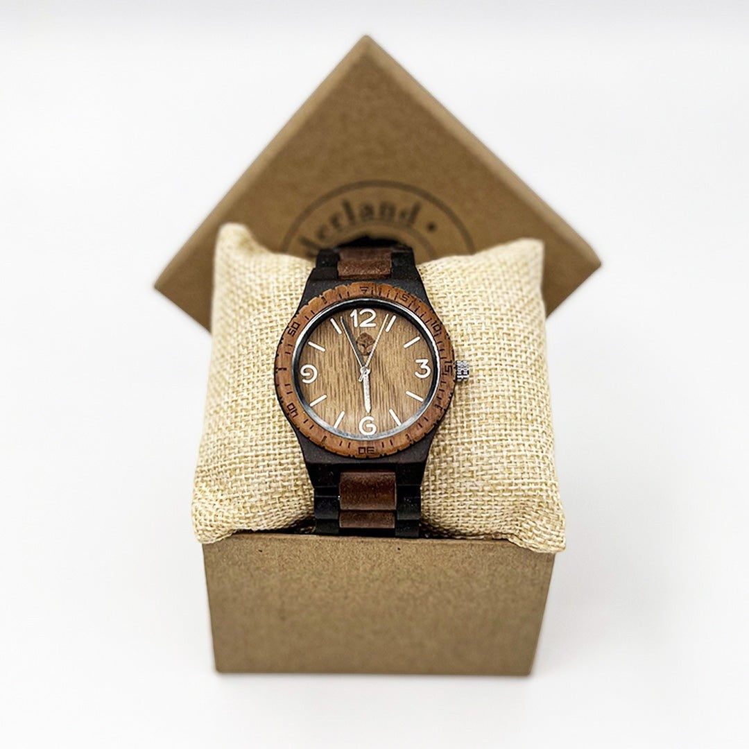Wooderland Venus wooden watch with bamboo and walnut finish, displayed on a burlap cushion inside a gift box.