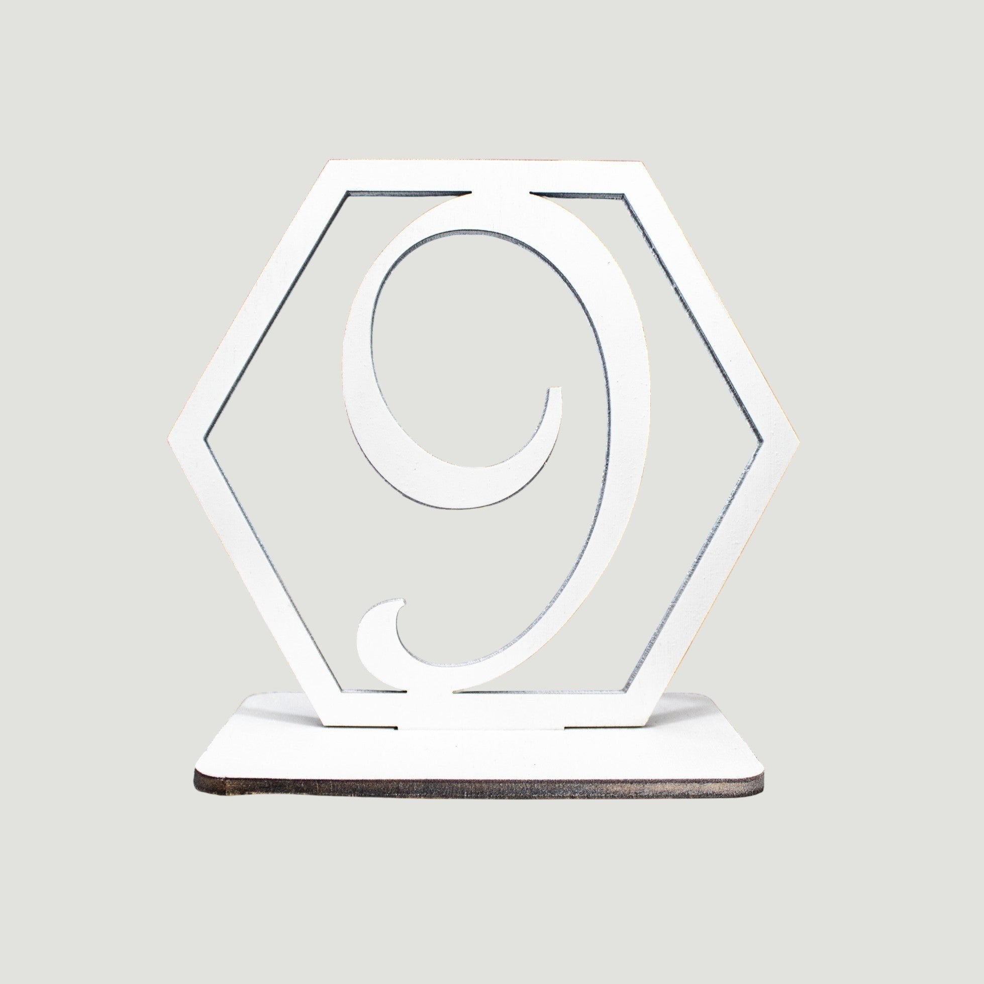 Wooderland white laser-cut wooden table number nine in a hexagonal frame for rustic wedding decor