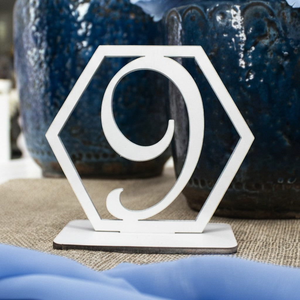 Wooderland white laser-cut wooden table number nine in a geometric hexagon frame for rustic wedding decor.