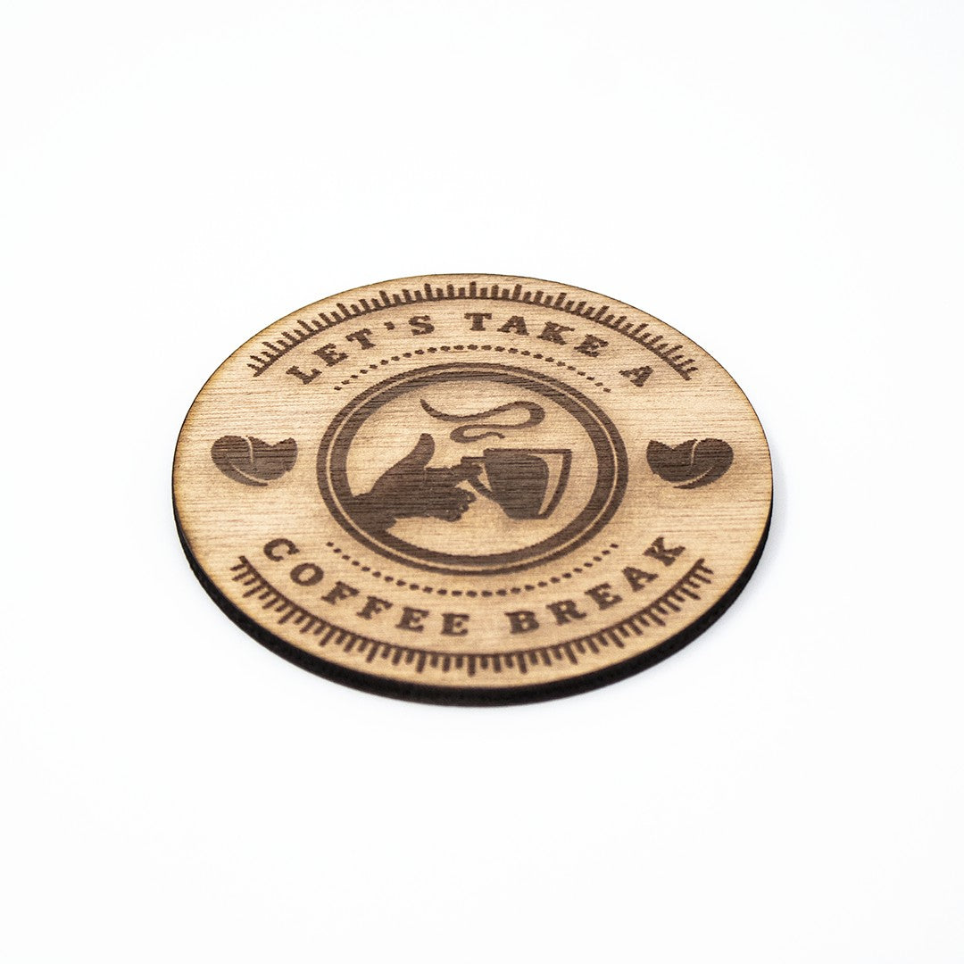 Wooderland round wooden coaster with Let's Take a Coffee Break laser-engraved design on a white background