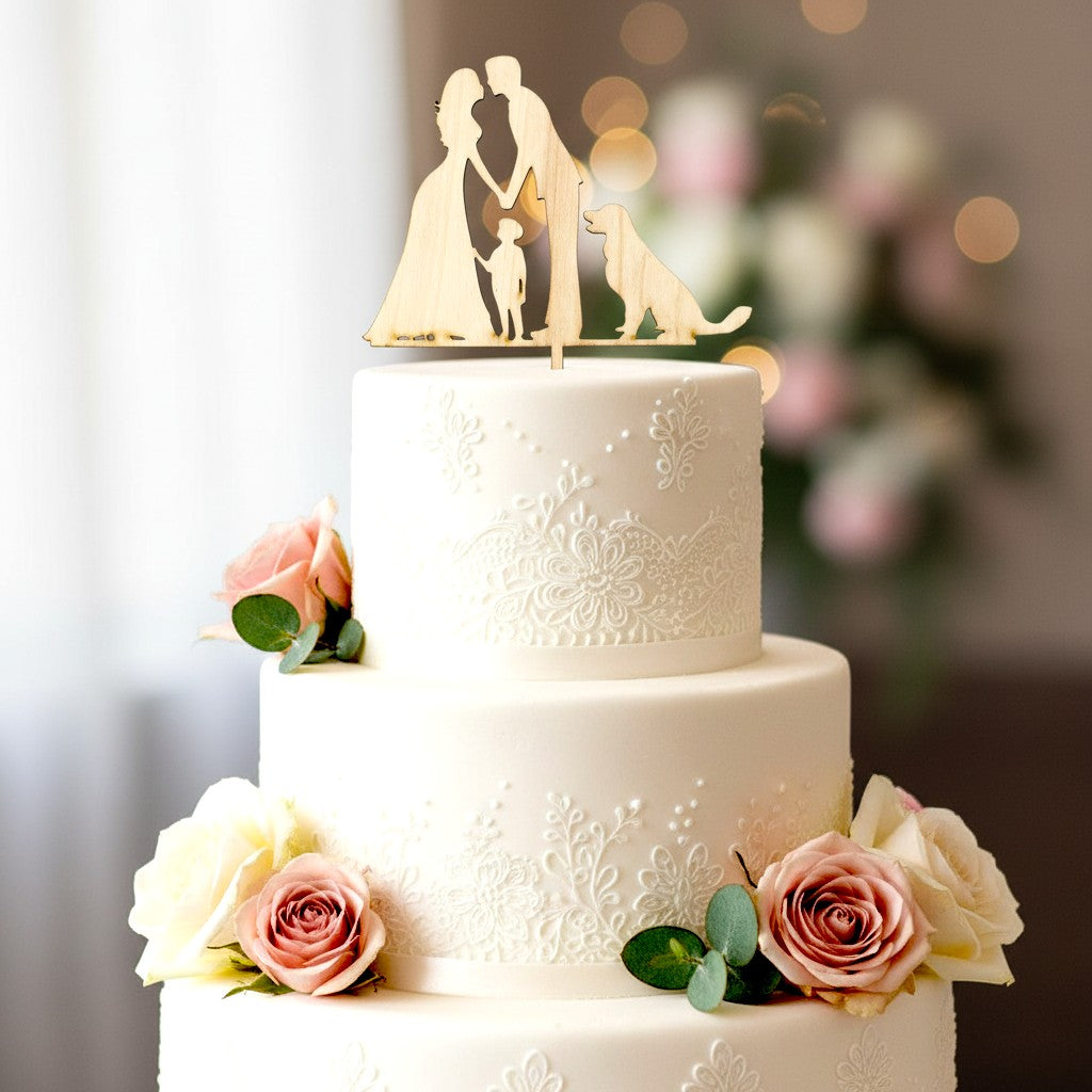 Wooderland wooden wedding cake topper featuring a bride, groom, child, and dog on a tiered white floral cake.