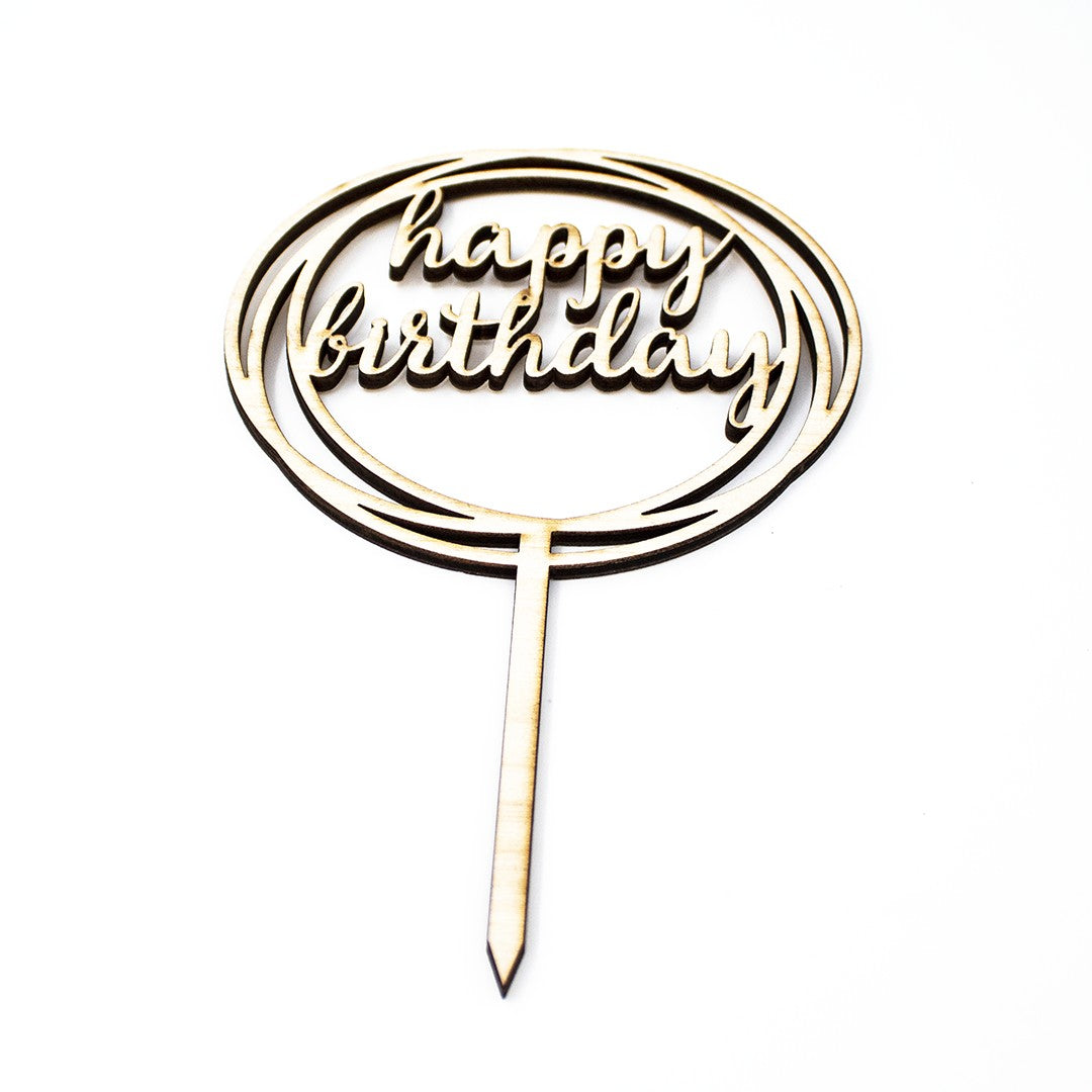Wooderland laser-cut wooden cake topper with a circular Happy Birthday design and smooth natural finish.