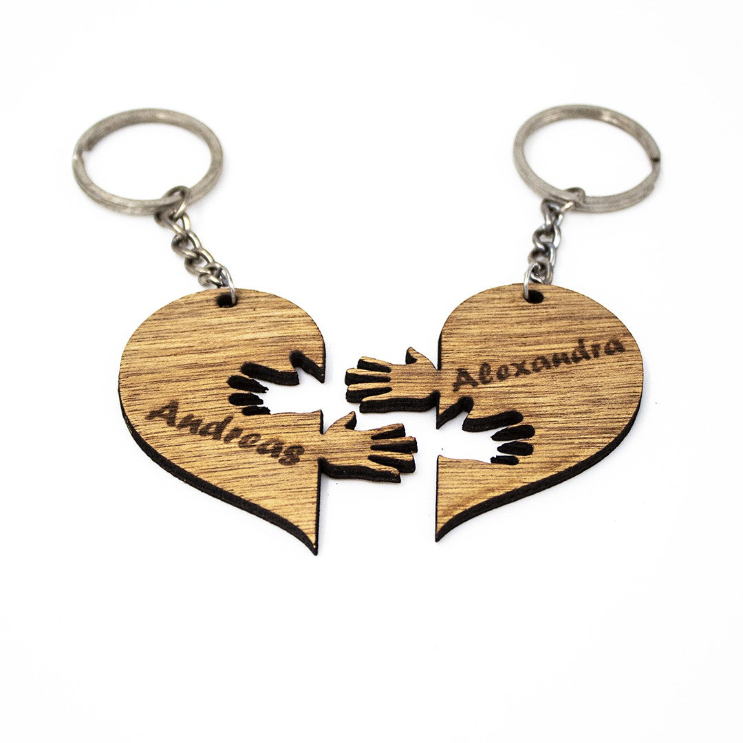 Wooderland matching wooden heart keyrings with engraved names and interlocking hand cutouts for couples