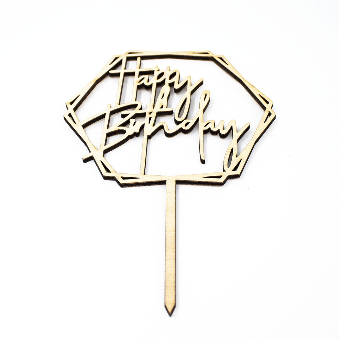 Wooderland laser-cut wooden Happy Birthday cake topper in a geometric hexagon frame with a smooth natural finish.
