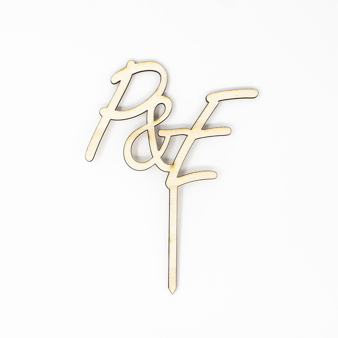Wooderland custom laser-cut wooden cake topper featuring two elegant monogram initials for a wedding cake.