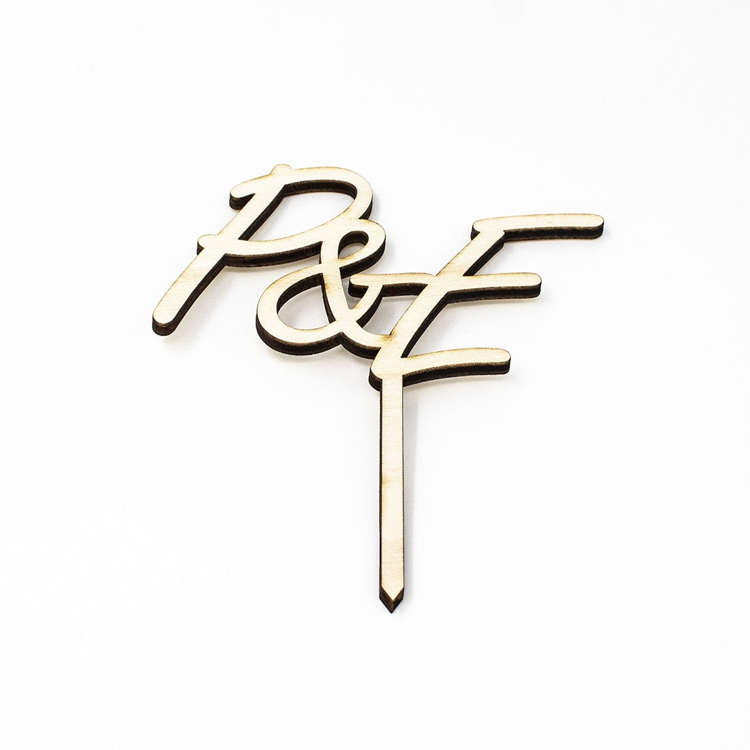 Wooderland custom laser-cut wooden cake topper featuring two elegant monogram initials for a wedding cake.